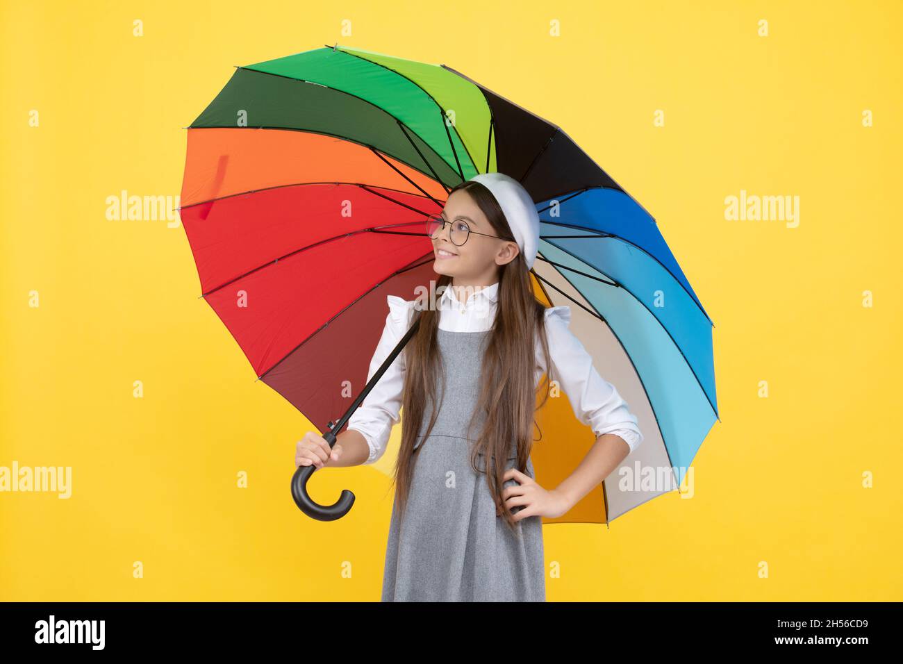 happy teen girl under colorful umbrella for rain protection in autumn season, rain protection. Stock Photo