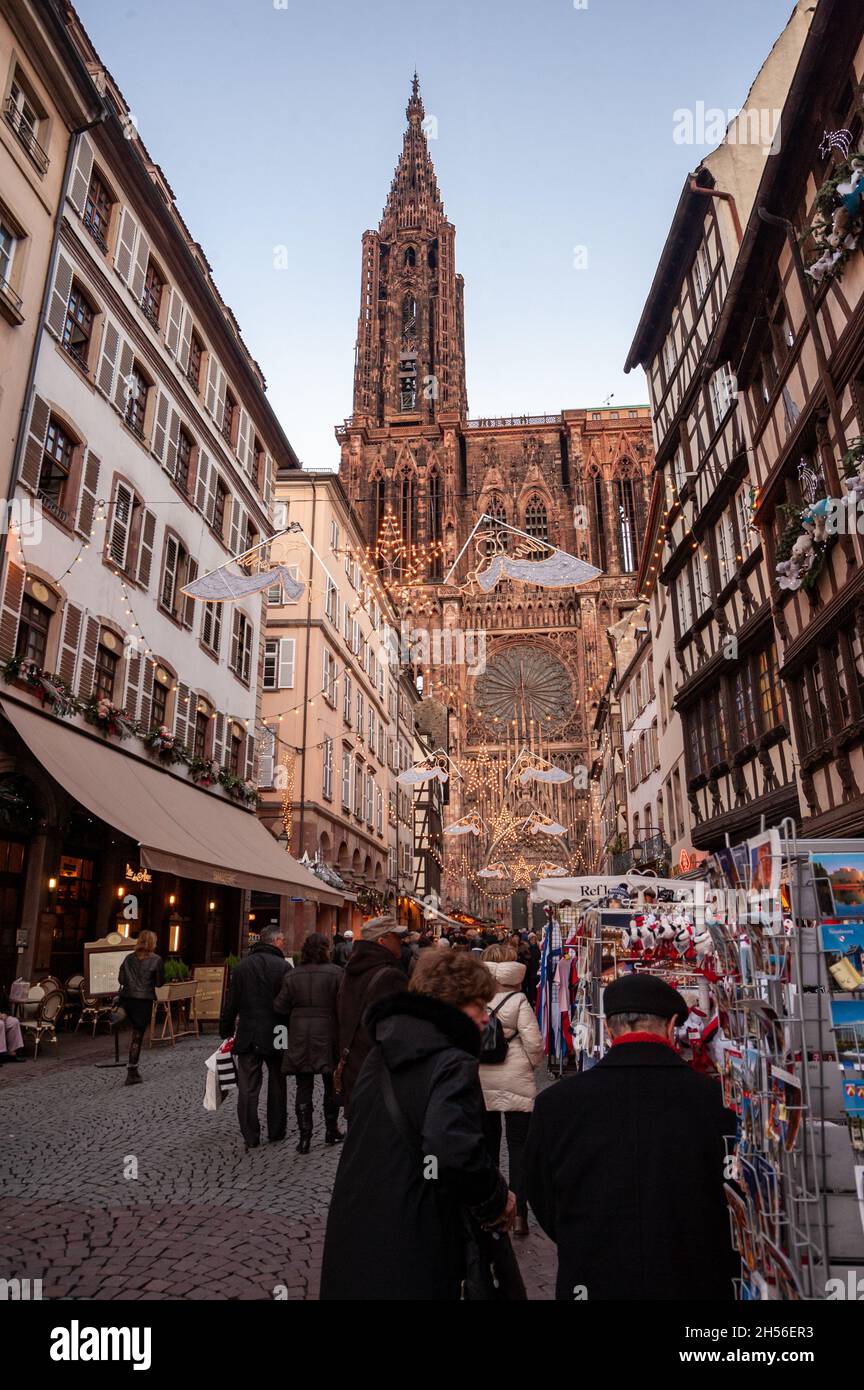 The cathedral of Strasbourg seen from the Merciere street. The historical center of Strasbourg near the cathedral is very crowded during Christmas. Stock Photo