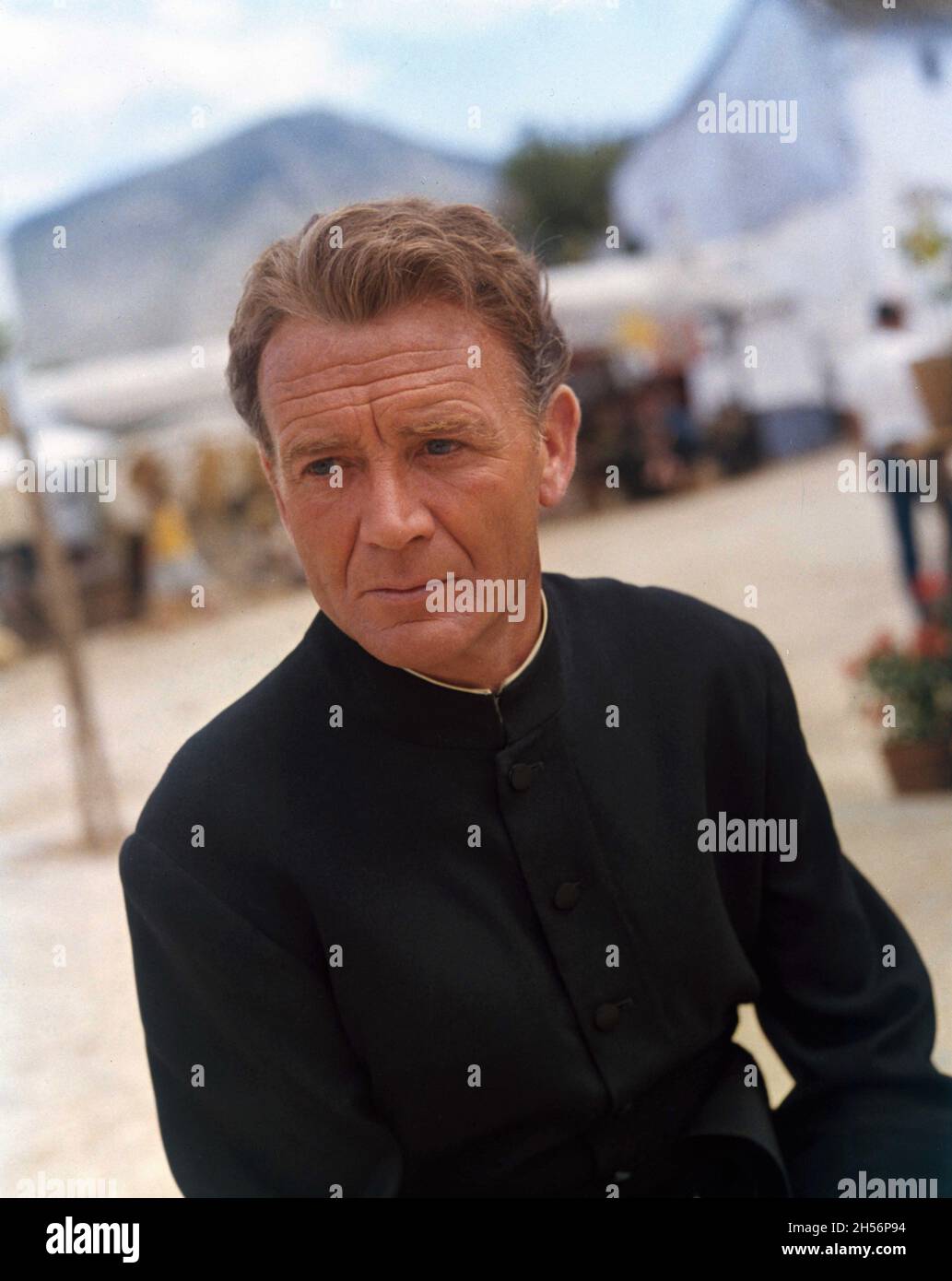JOHN MILLS in costume as Father Keogh on set candid portrait during filming of THE SINGER NOT THE SONG 1961 director GEORGE WARD BAKER novel Audrey Erskine-Lindop screenplay Nigel Balchin costume design Yvonne Caffin The Rank Organisation Stock Photo