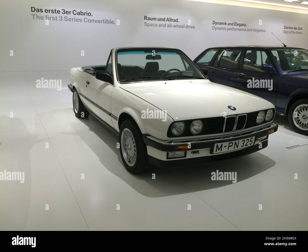BMW 3 Series (E30): Front view, white color, cabriolet, 1st series 3 cabriolet, 2nd generation, manufactured in 1981-1994. BMW Museum, Munich - German Stock Photo