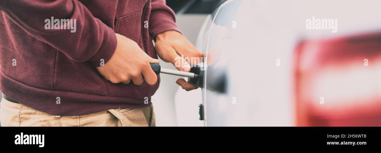 Car theft man thief breaking in automobile with tool to steal panoramic banner background Stock
