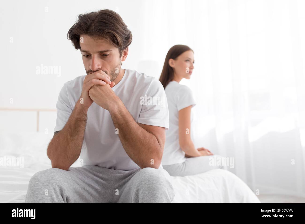 Sad Upset Offended Millennial Caucasian Man Sitting On Bed Ignoring