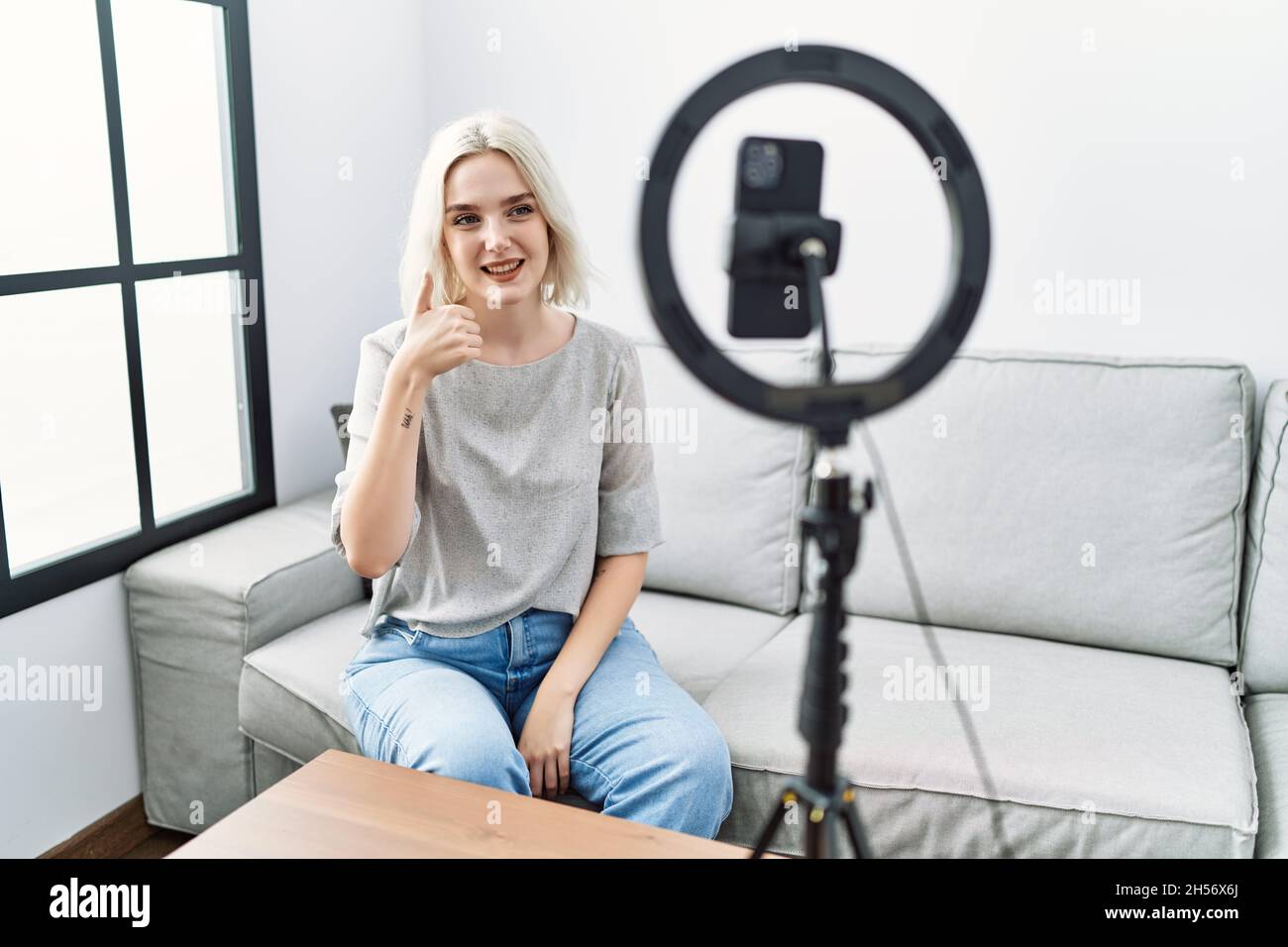 Young caucasian woman recording vlog tutorial with smartphone at home ...