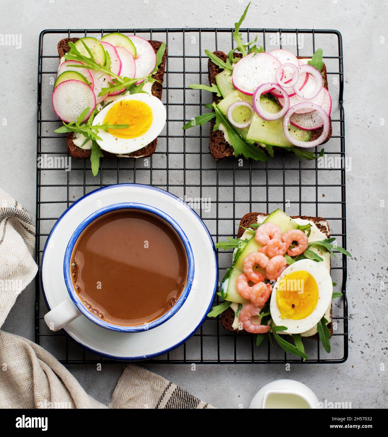 Open sandwiches on dark rye bread with eggs, shrimps, radishes
