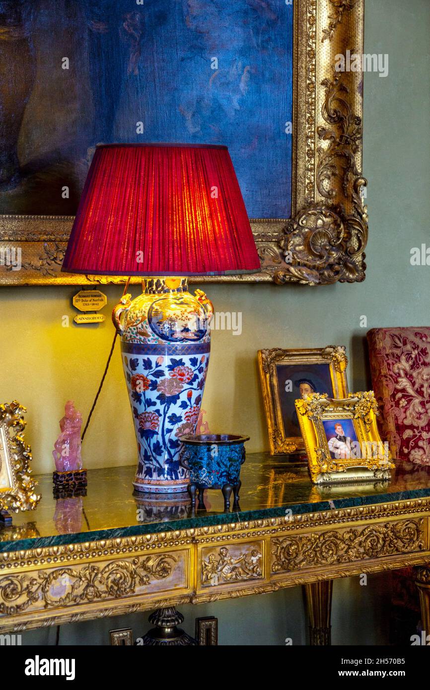 Table lamp and ornate, golden console table at the Drawing Room of Arundel Castle, West Sussex, UK Stock Photo