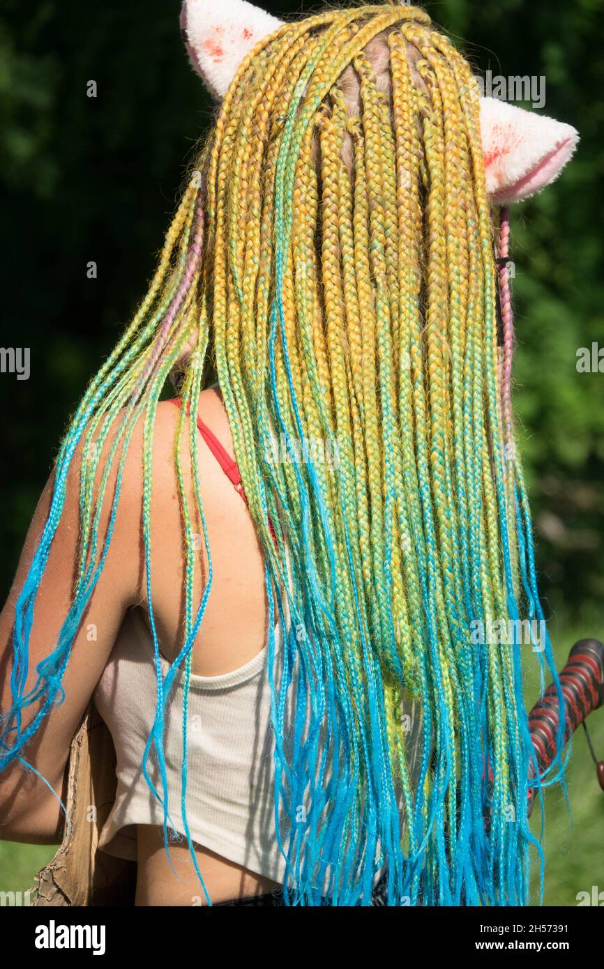Dreadlocks of teenage girl colorful hair style braids Stock Photo