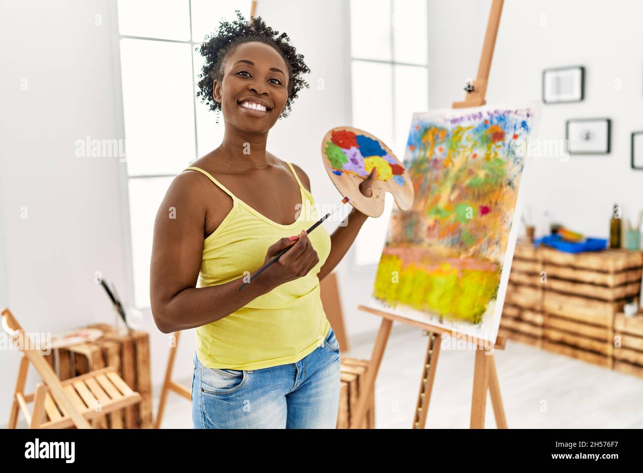 Young african american artist woman smiling happy drawing at art studio ...