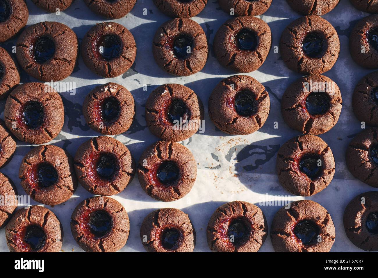 High angle view on baking tray with one missing homemade cocoa cookie. Stock Photo