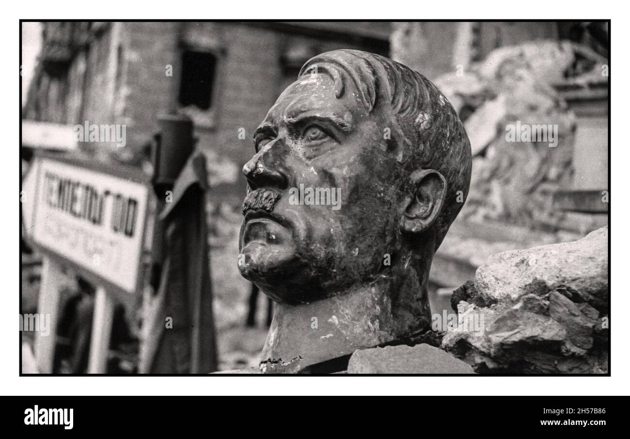 Bust of Adolf Hitler lies by the roadside damaged by the street flighting of the advancing allied troops on Nazi Berlin Germany Stock Photo