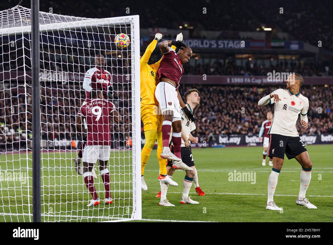 London, UK. 07th Nov, 2021. Angelo Ogbonna of West Ham United challenges  Alisson Becker of Liverpool as Pablo Fornals of West Ham United scores  their first goal direct from a corner to