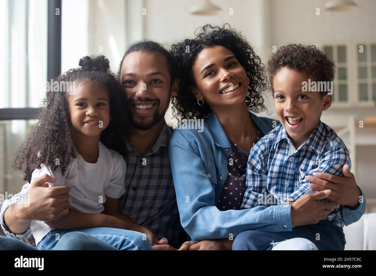 Happy young Black family posing on photo shooting Stock Photo - Alamy