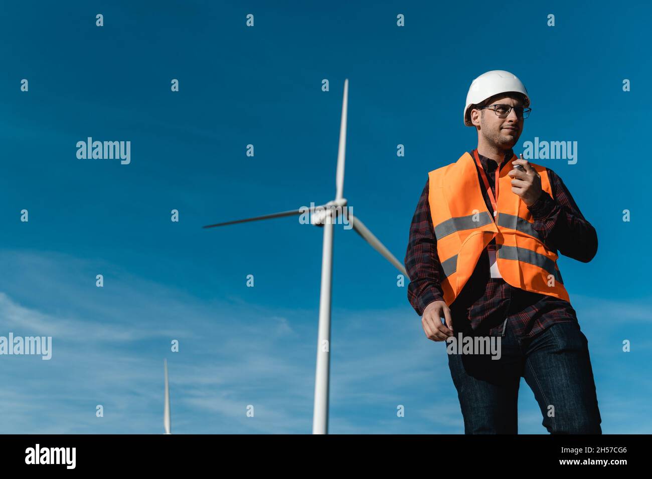 Worker inside sustainable energy industry - Engineer working at alternative renewable wind energy station Stock Photo