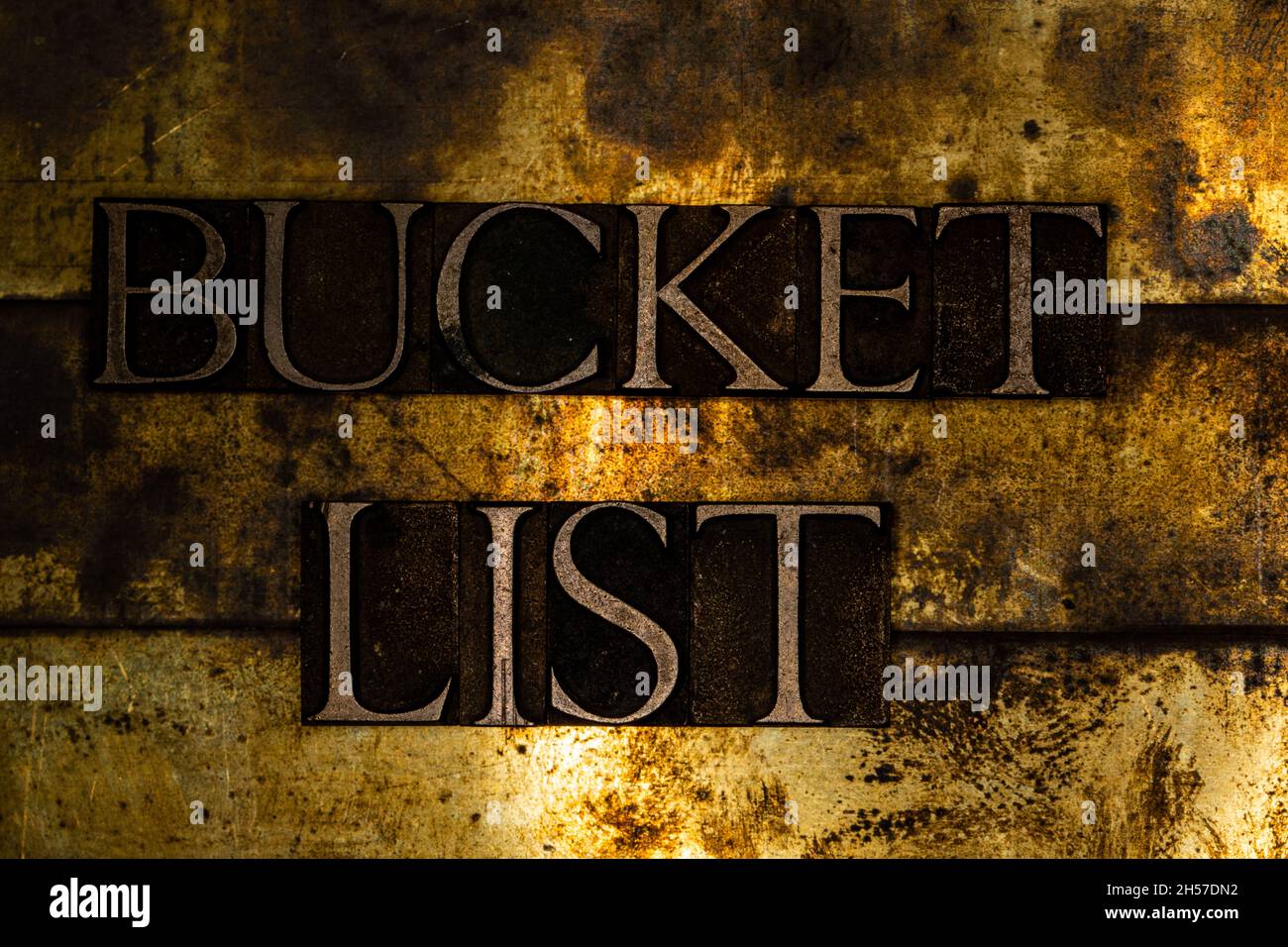 Bucket List text message on textured grunge copper and vintage gold background Stock Photo