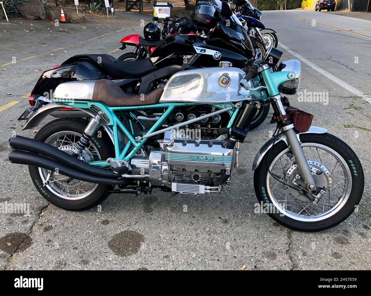 Antique BMW motorcycle, customized in chrome and green. Parked next to other motorcycles. Los Angeles, United States. Stock Photo