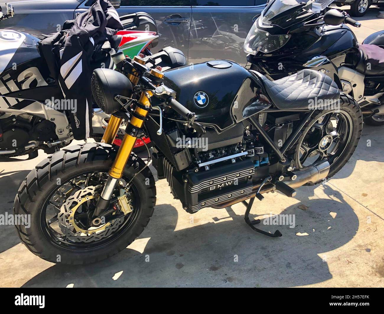 Old, customized BMW motorcycle . Parked next to other motorcycles. Los Angeles, United States. Stock Photo