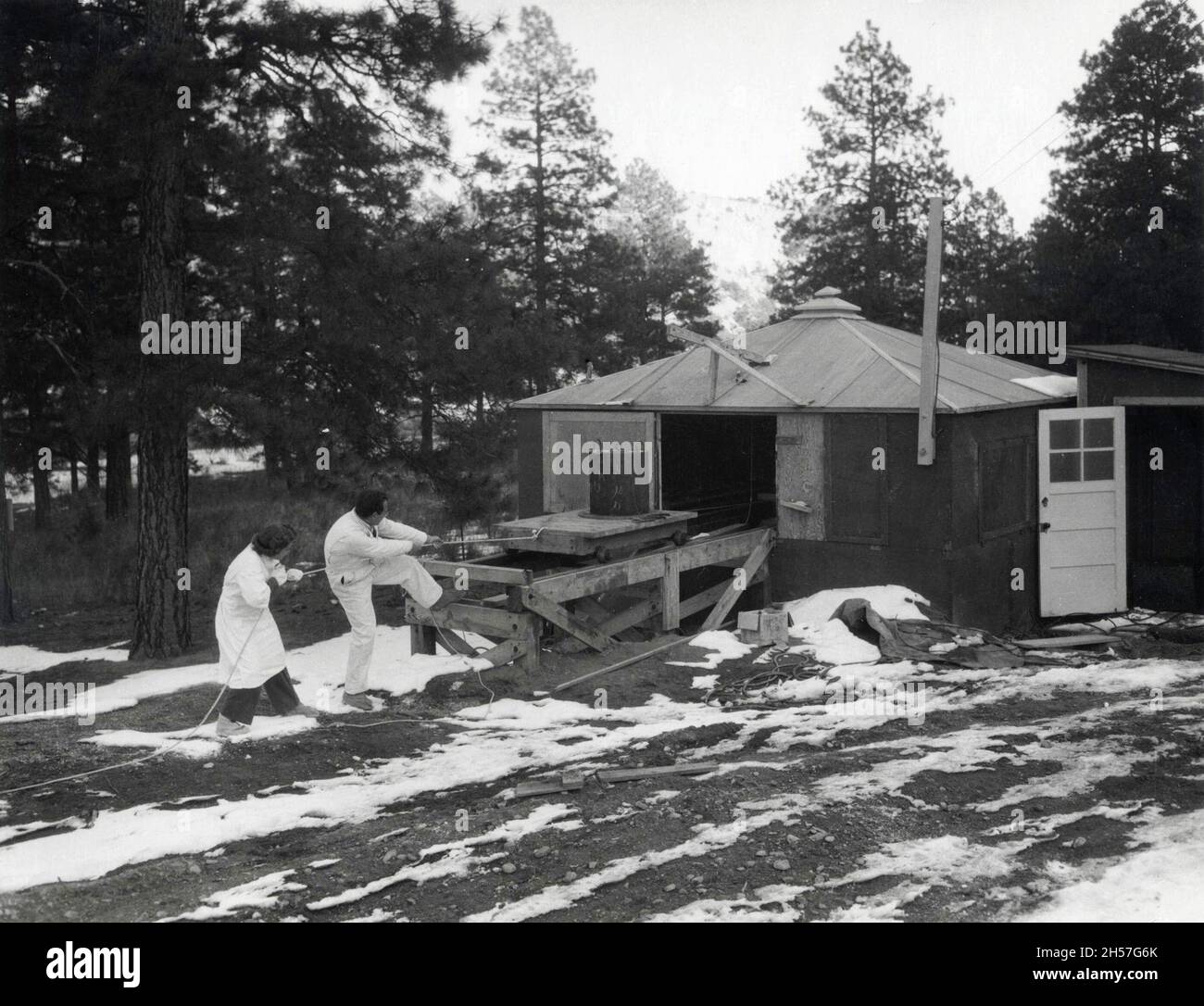 Workers remote handling radioactive Lanthanum during the Manhattan Project Stock Photo