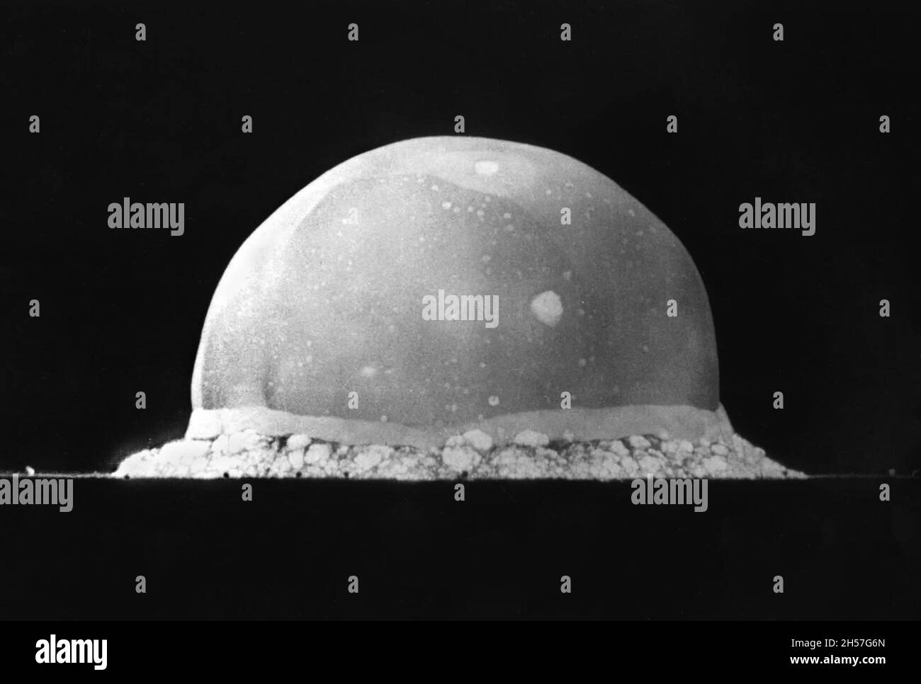 The world's first ever nuclear explosion at the Trinity test site in New Mexico during the Manhattan Project. This image is taken just 16 milliseconds after the detonation. The dome of plasma is already 200m high which means it's expansion rate is 12.5km per second Stock Photo