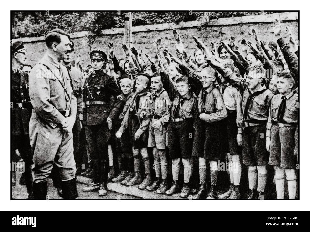 HITLER YOUTH HEIL HITLER  Nazi Propaganda image of Adolf Hitler with impressionable young 8-12 years Hitlerjugend Hitler Youth boys saluting Adolf Hitler in Leipzig, Nazi Germany 1932 Stock Photo