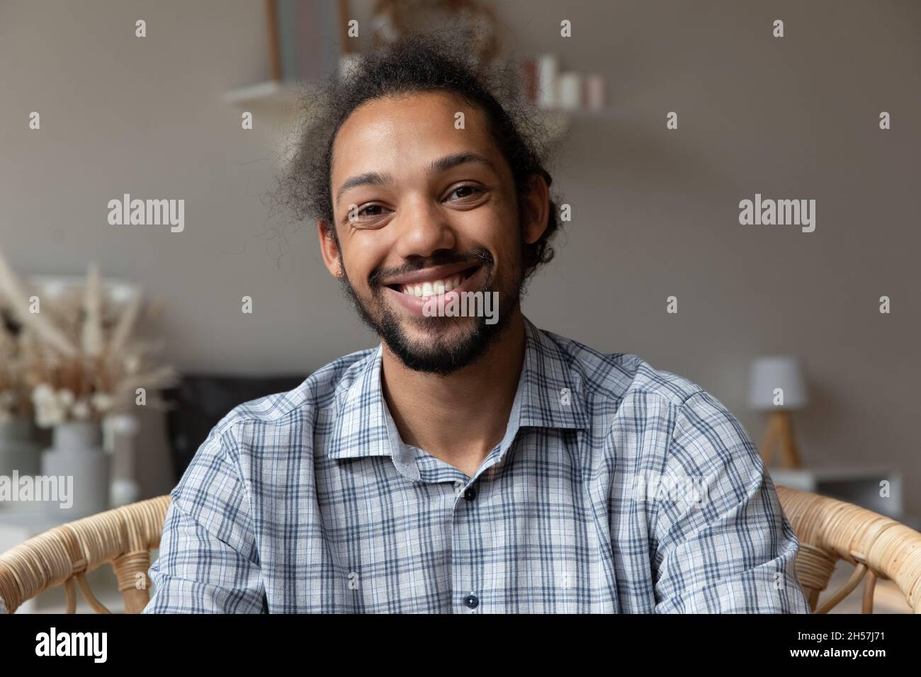 Happy millennial African American hipster guy looking at camera Stock Photo
