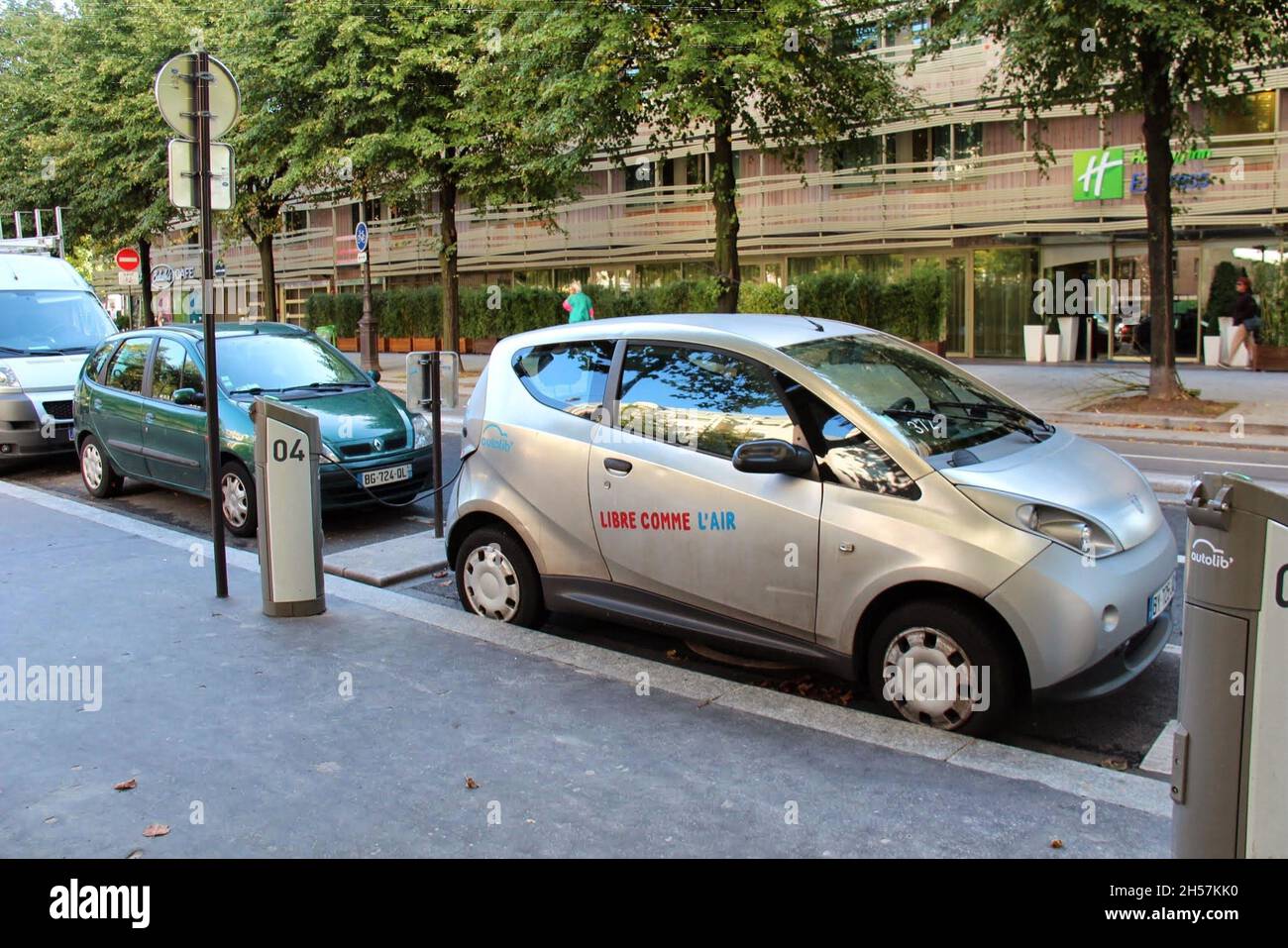 Electric car charging station, fueling a car on the streets of Paris