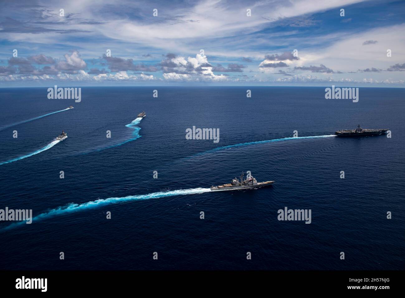 South China Sea, United States. 30 October, 2021. The U.S. Navy Nimitz-class aircraft carrier USS Carl Vinson and the Japan Maritime Self-Defense Force Izumo-class helicopter destroyer JS Kaga, lead a formation during joint operations October 30, 2021 in the South China Sea. Sailing are the USS Shiloh, USS Lake Champlain, USS Carl Vinson, USS Milius, JS Murasame and JS Kaga. Credit: MC2 Haydn Smith/U.S. Navy/Alamy Live News Stock Photo