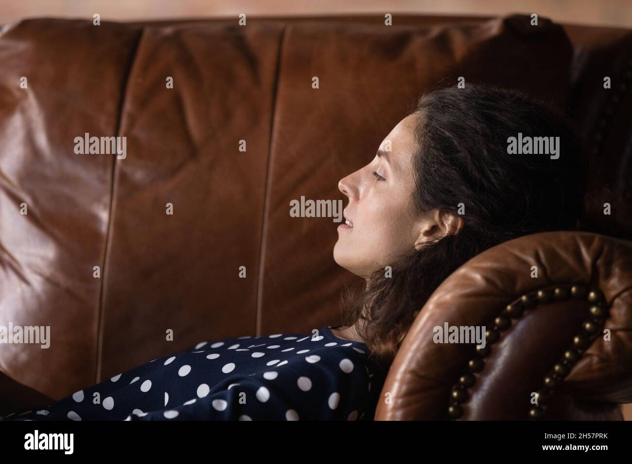 Millennial female patient lie on comfy couch at psychologist cabinet Stock Photo