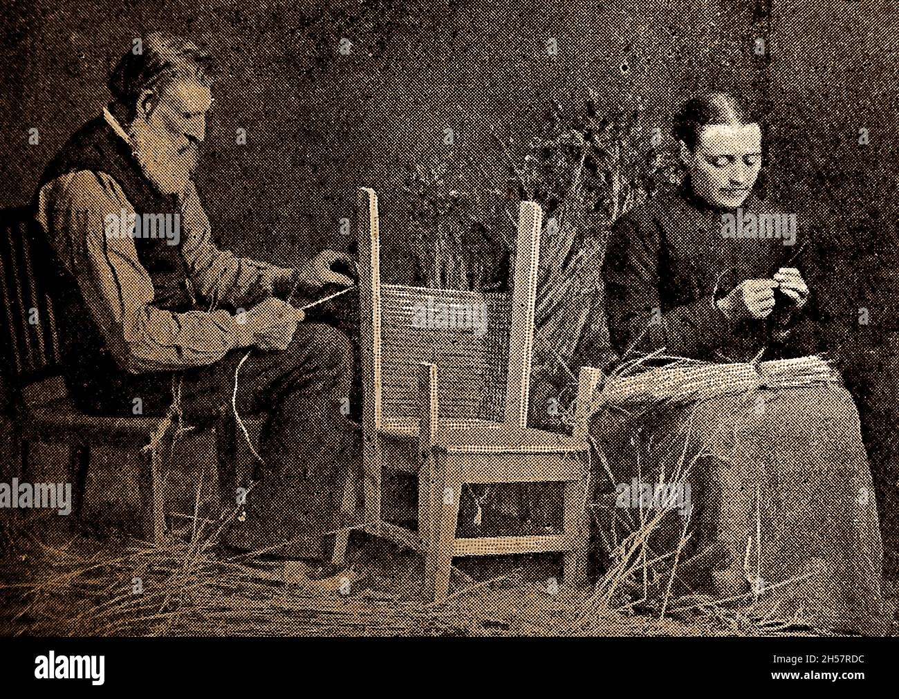 1908 image taken in Orkney, Scotland - An Orkney couple (Scotland) in 1908 making a straw-backed chair. Stock Photo