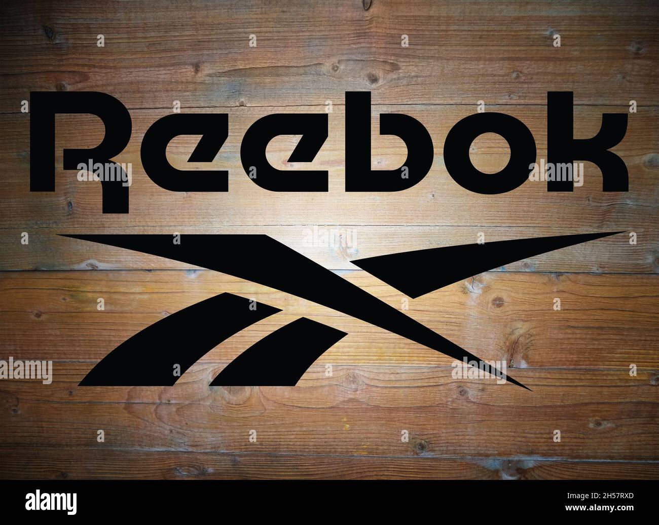 Reebok logo on wooden background Stock Photo - Alamy