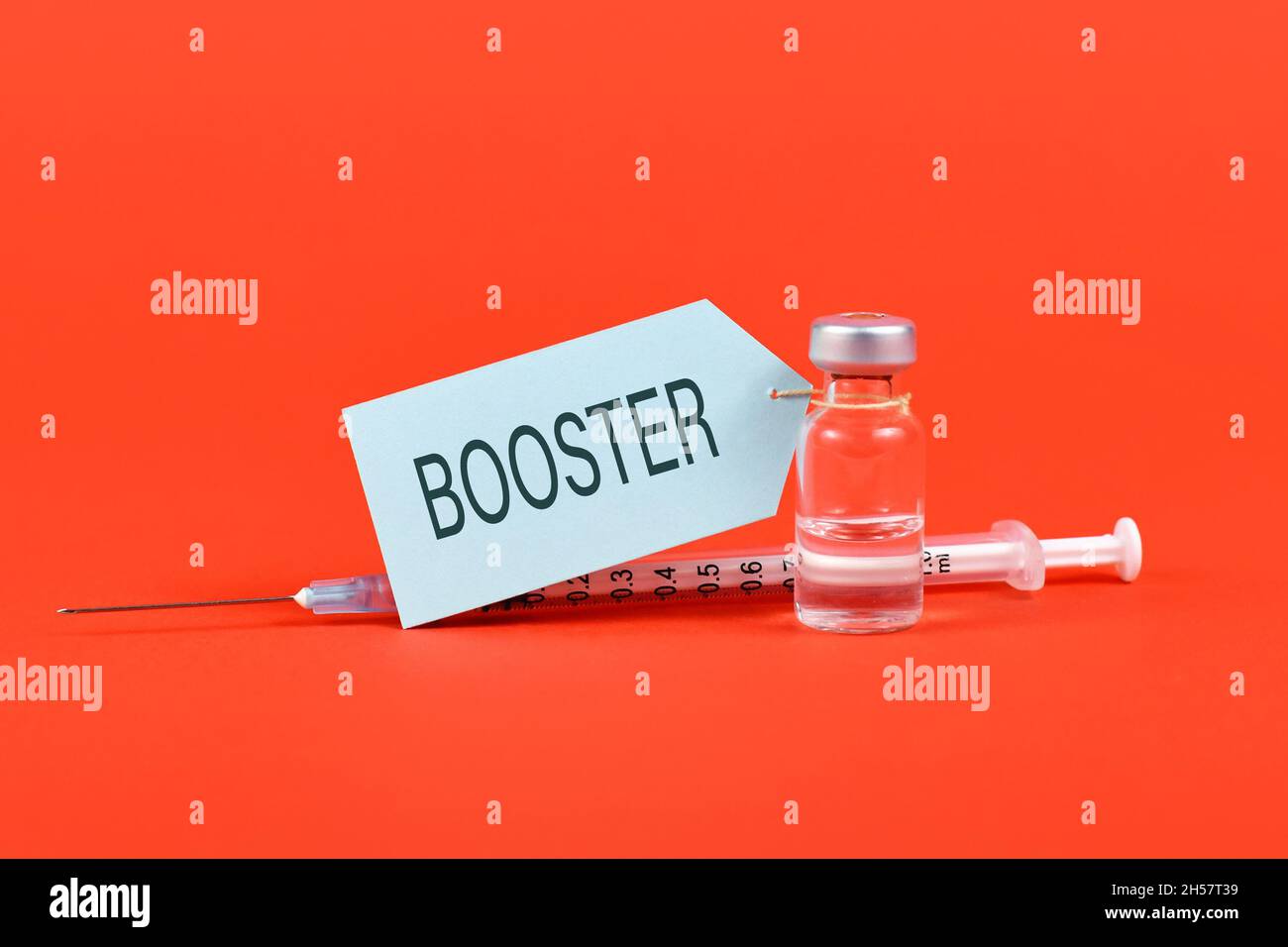 Concept for Corina virus booster vaccination with vial and syringe on red background Stock Photo