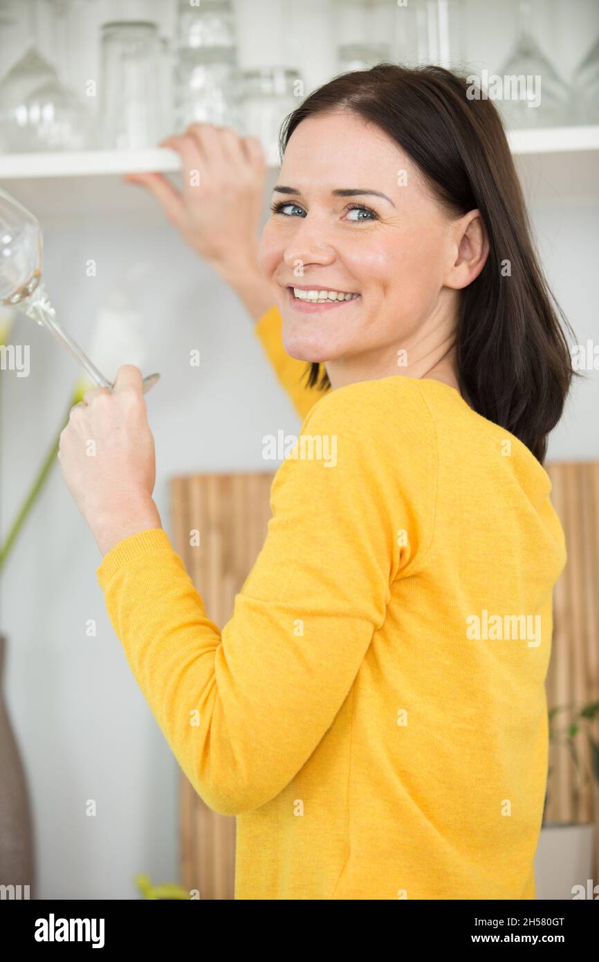 a beautiful woman cleaning cupboard Stock Photo