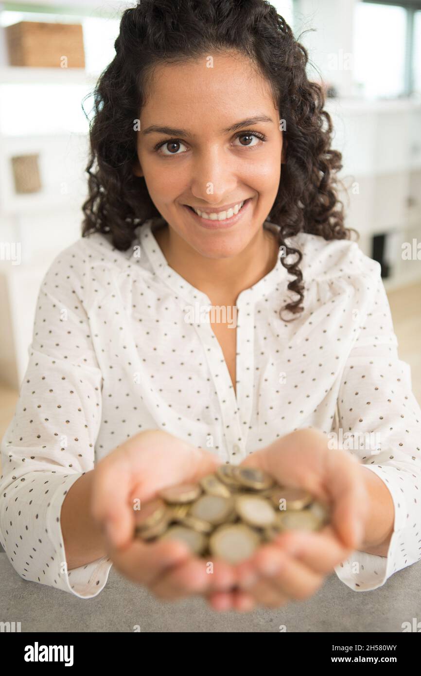 picture of woman holding coins Stock Photo Alamy