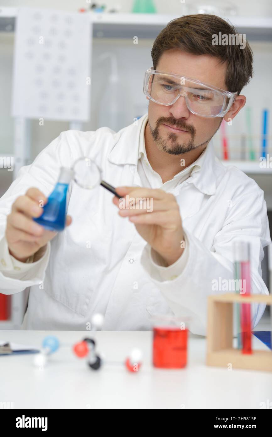 man checking liquids in the lab Stock Photo