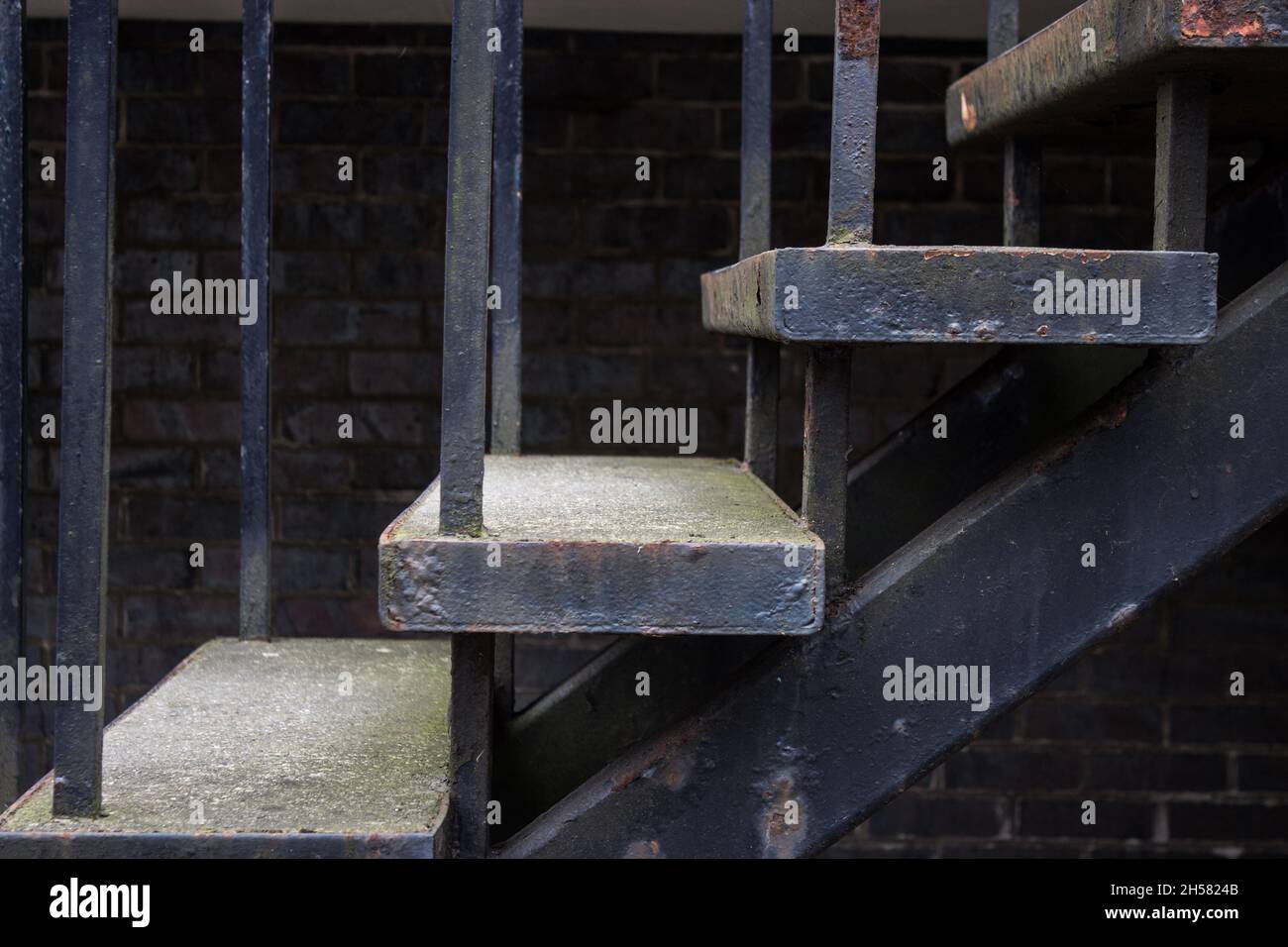 Outdoor Staircase, Steps, Stairs, Rusting Metal, Brick Wall in Background Stock Photo