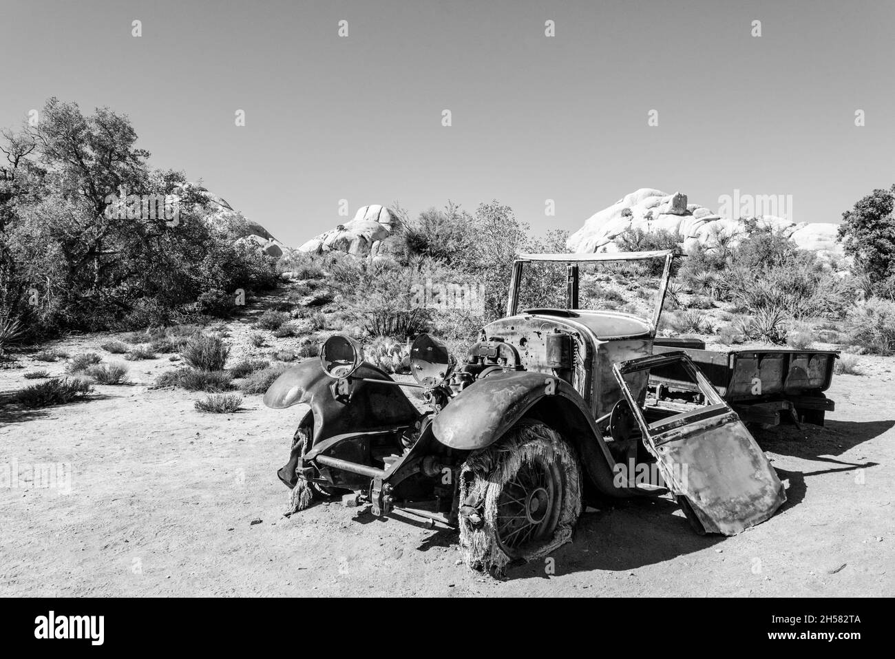 Old antique car wrecks from the old gold rush time in Joshua Tree National Park, USA Stock Photo