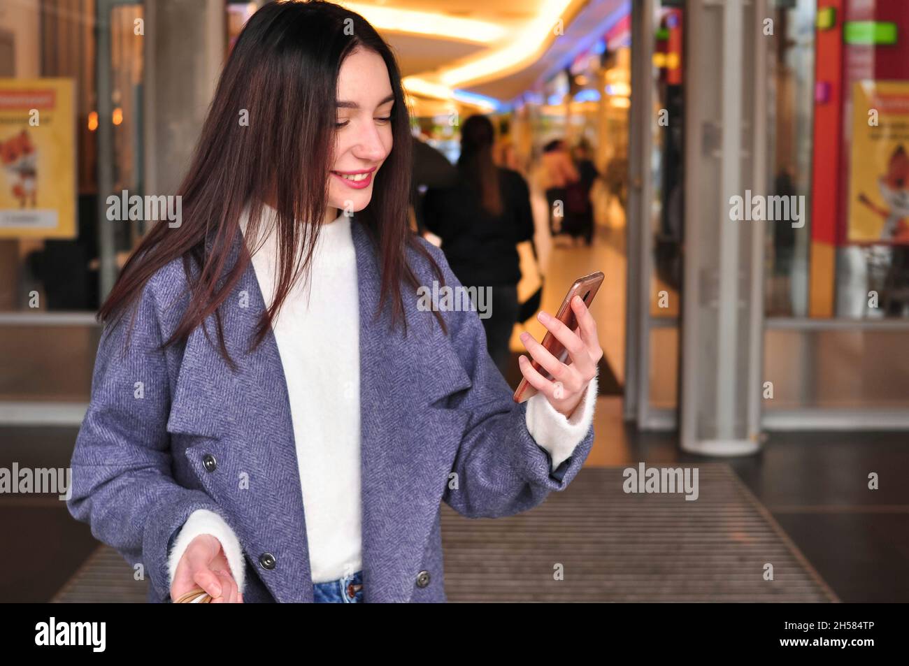 Young brunette woman with shopping bags makes a video call outside . High quality photo Stock Photo