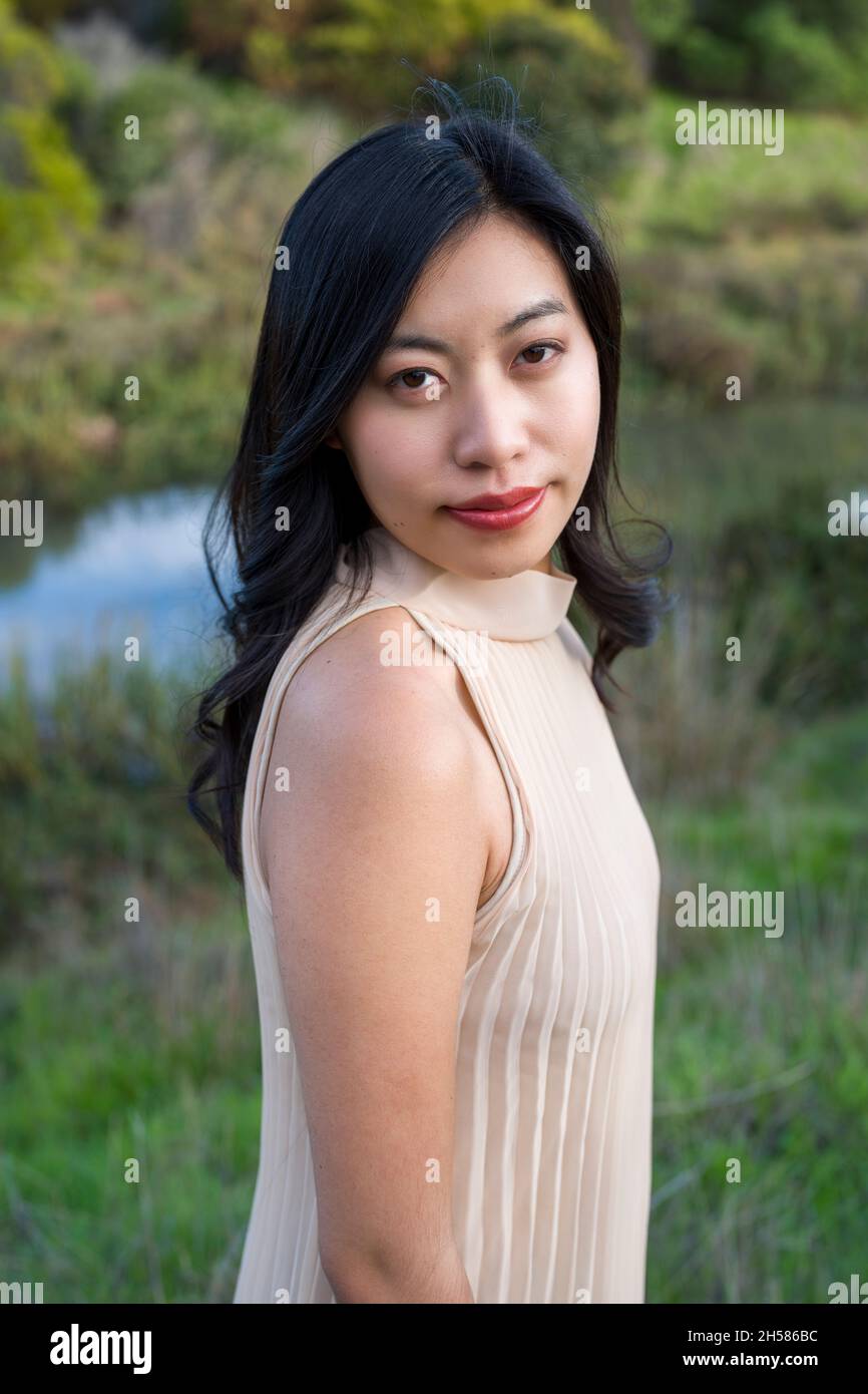 Young Asian Woman in a Beige Dress Walking in the Marshlands Stock Photo -  Alamy