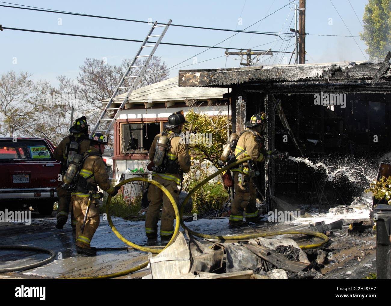San Diego Fire-Rescue firefighters working a structure fire in Mission Village. Stock Photo
