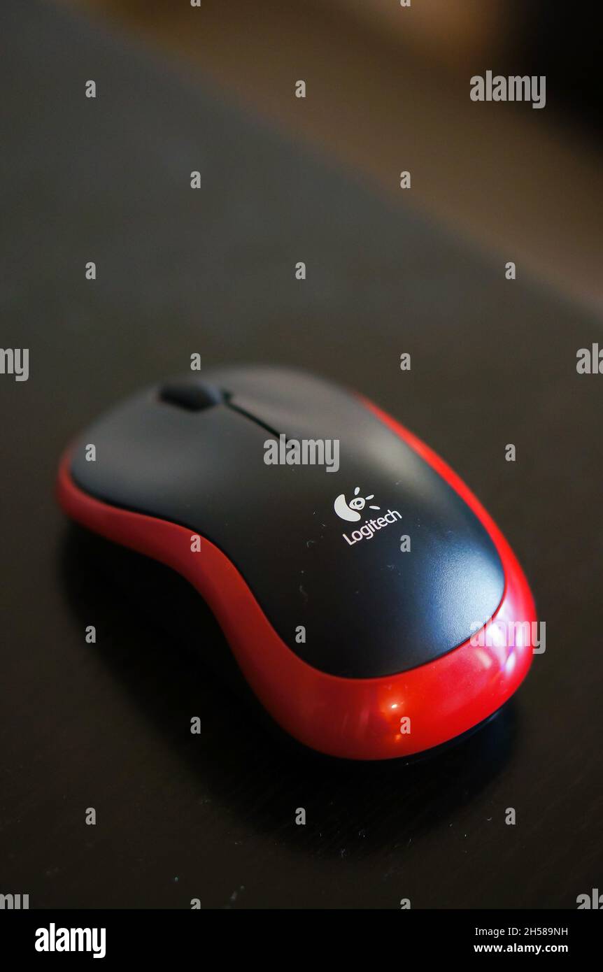 POZNAN, POLAND - Dec 27, 2015: A vertical shot of a Logitech brand plastic computer mouse on a table Stock Photo