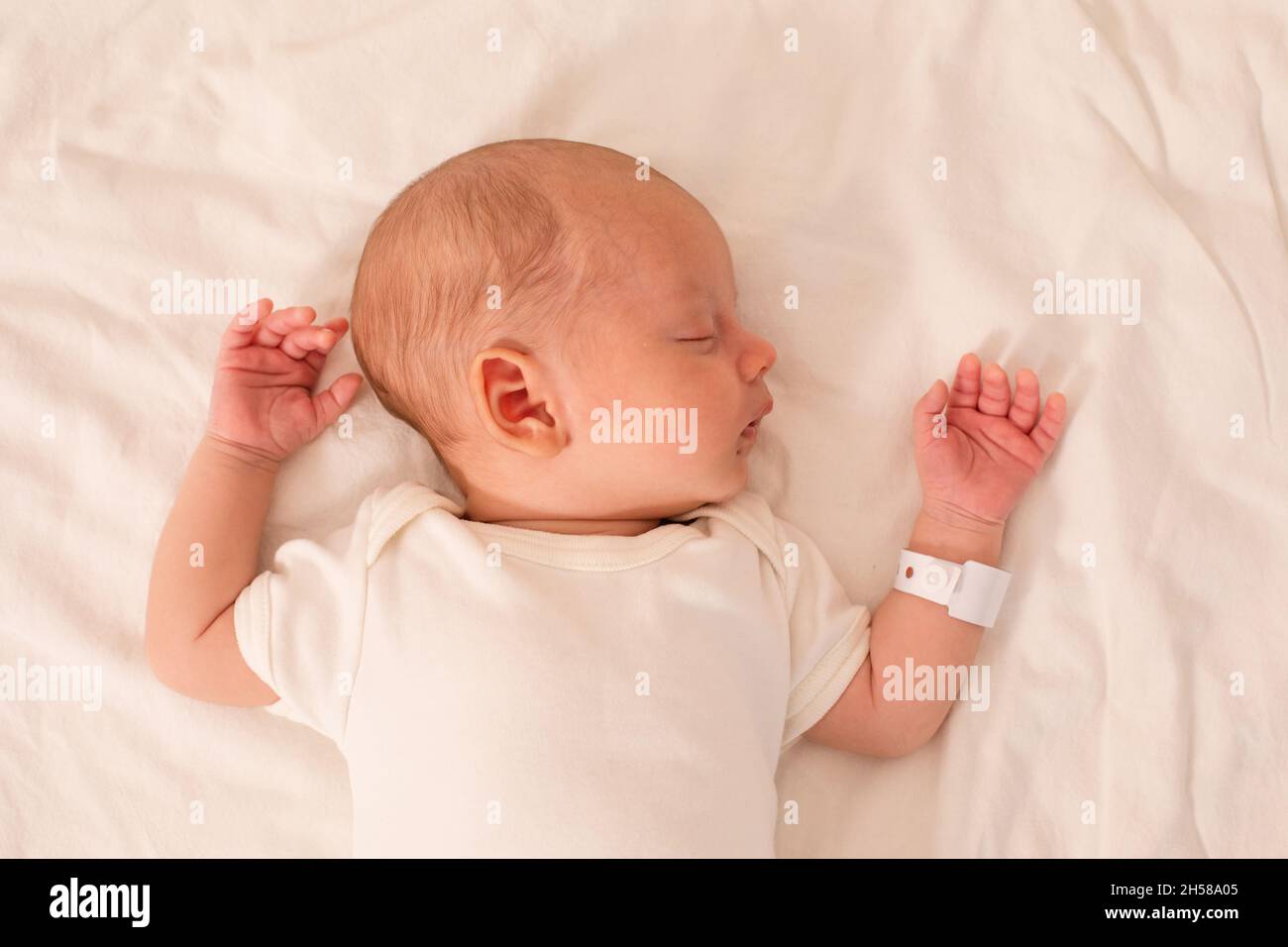 The newborn baby sleeps on the bed in the maternity hospital Stock Photo Alamy