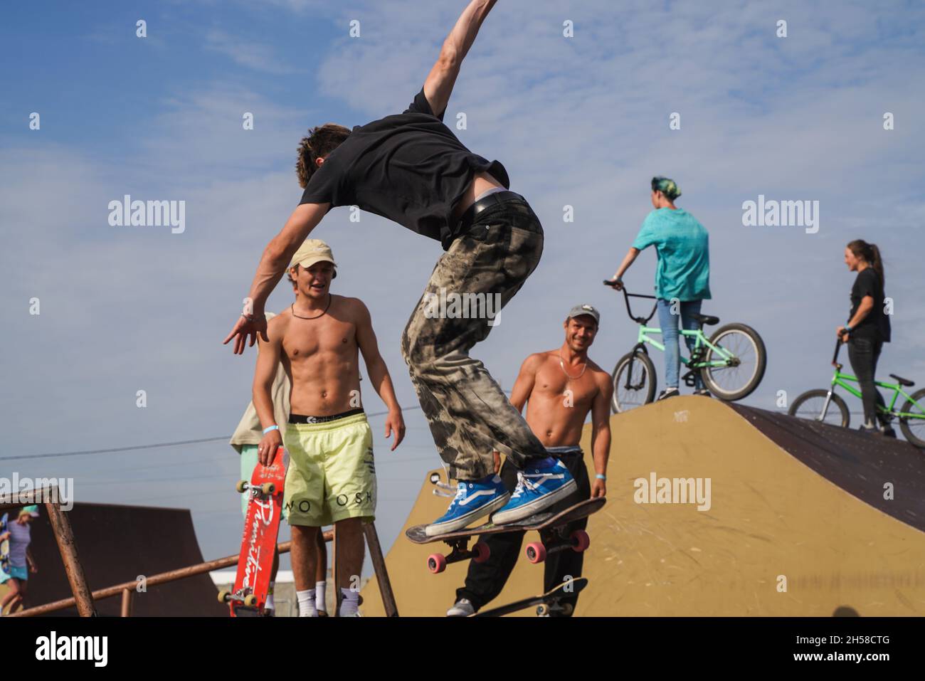 Olenevka, Russia - July 22, 2021: skateboarder jumping in a bowl of a skate park. High quality photo Stock Photo
