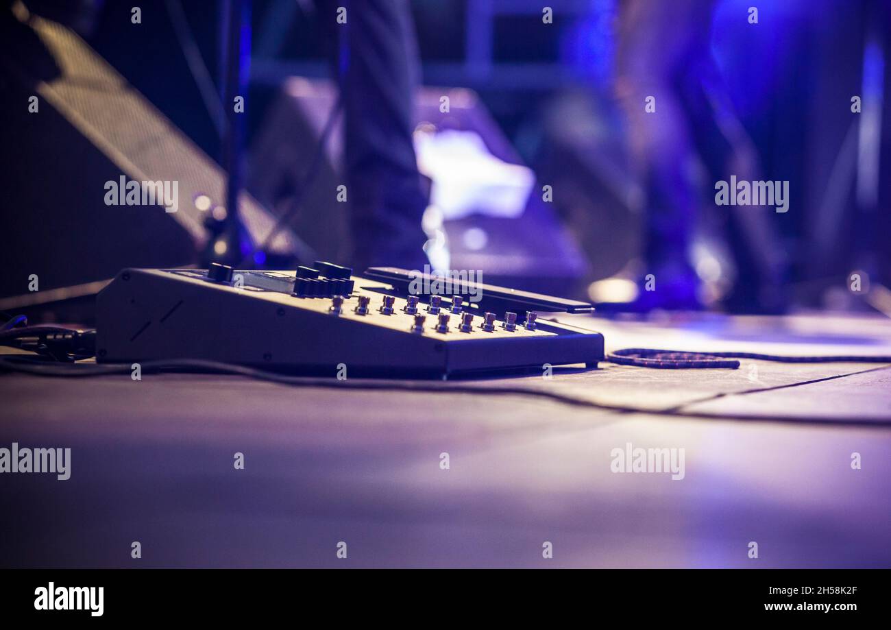Guitarist pedal effects. Hard rock musicians performing. Stock Photo