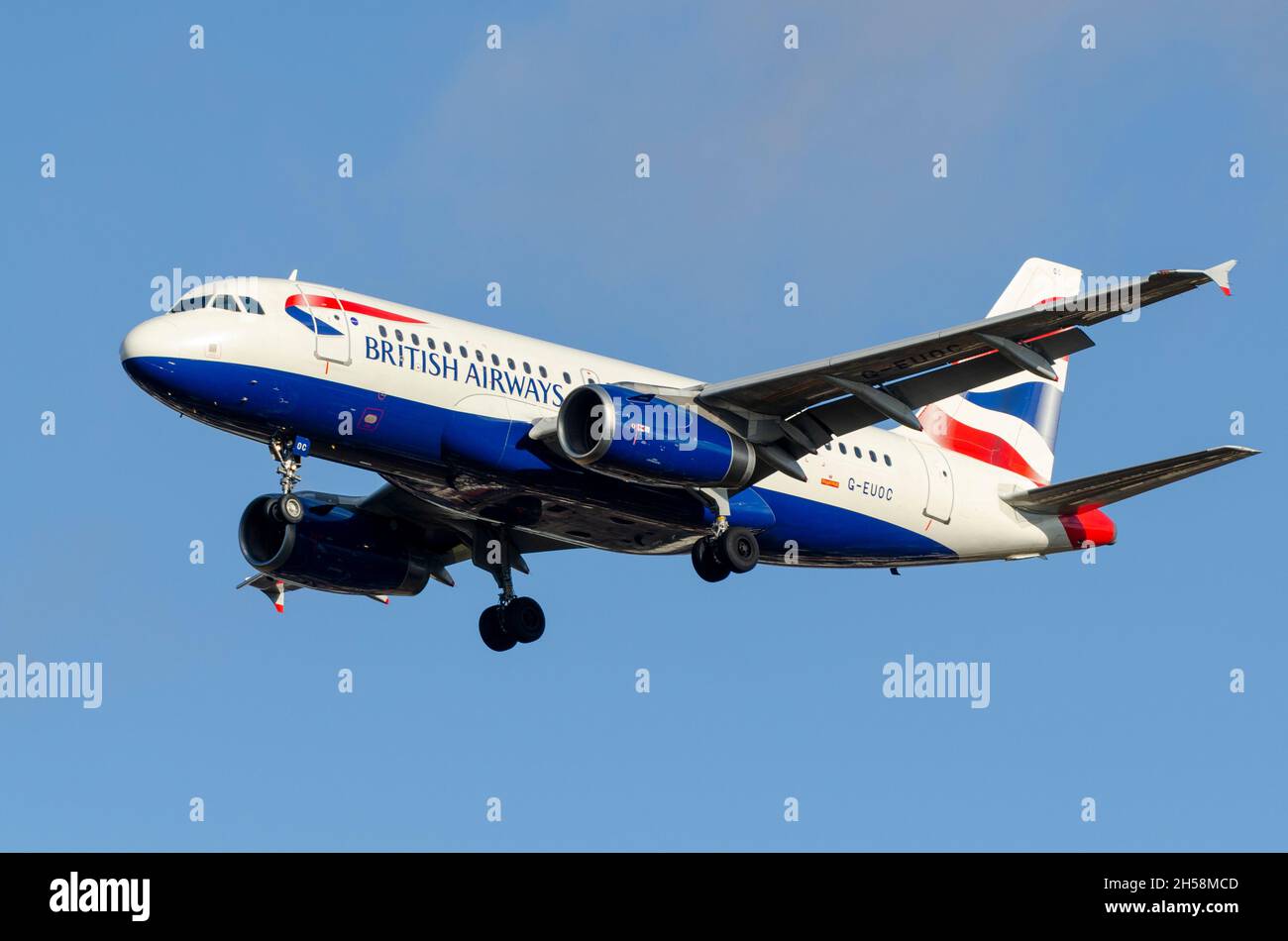 British Airways Airbus A319 airliner jet plane G-EUOC on approach to land at London Heathrow Airport, UK, in blue sky. Old, small short haul airplane Stock Photo