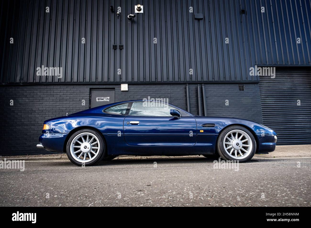 Aston MArtin DB7 parked on an industrial side street Stock Photo