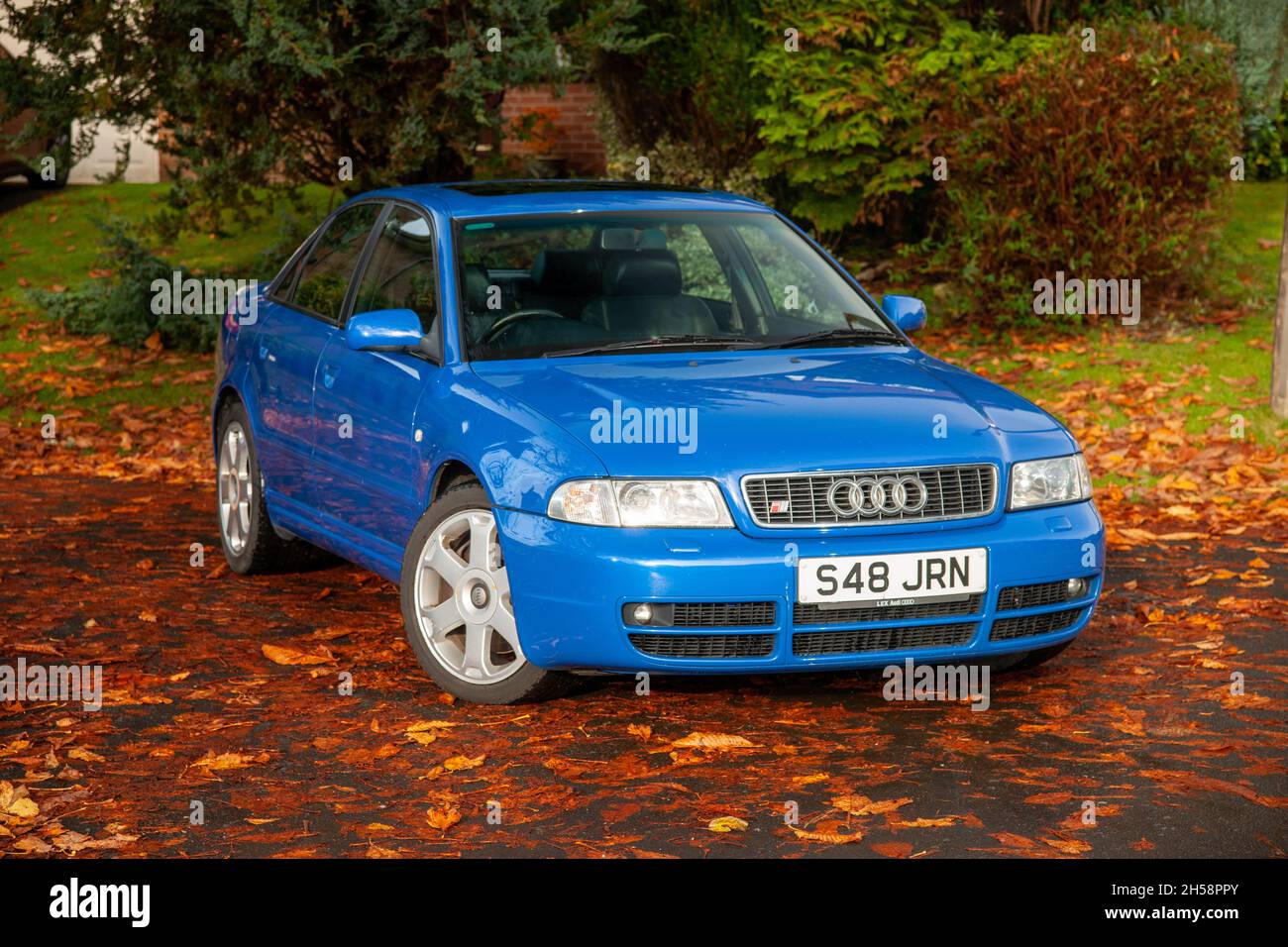1999 model year Audi S4 saloon parked on a leaf strewn suburban street in early Autumn Stock Photo