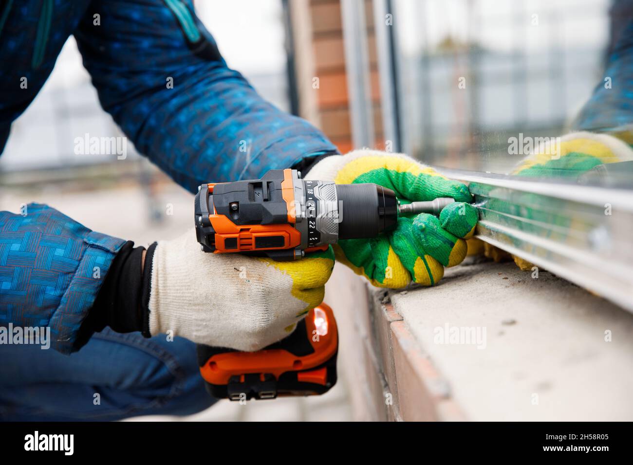 The wizard is engaged in installing windows. Repair work Stock Photo