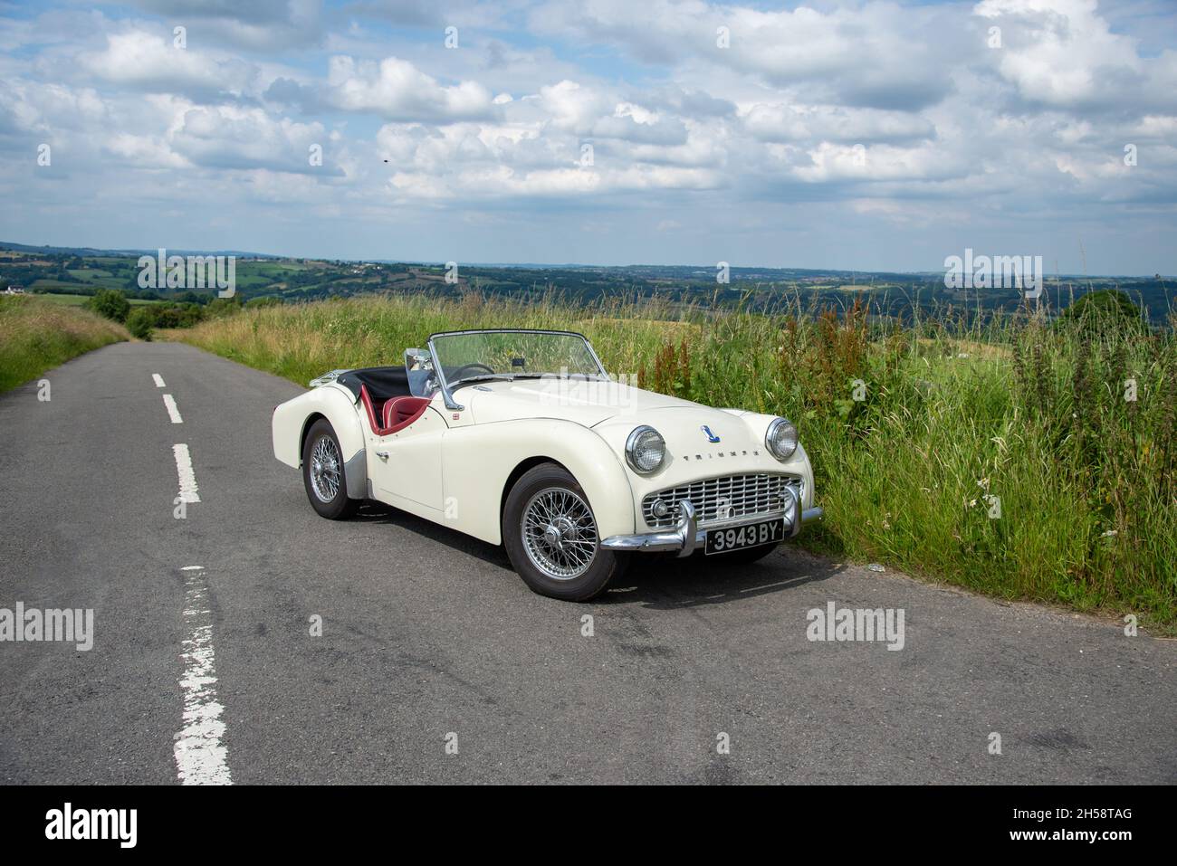 Triumph TR3 classic car parked on a country lane in Derbyshire Stock