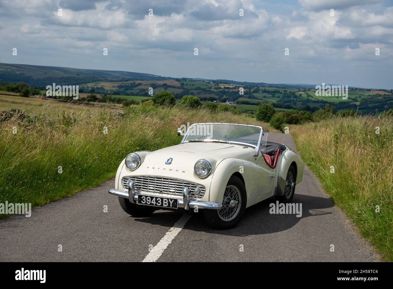 Triumph TR3 classic car parked on a country lane in Derbyshire Stock
