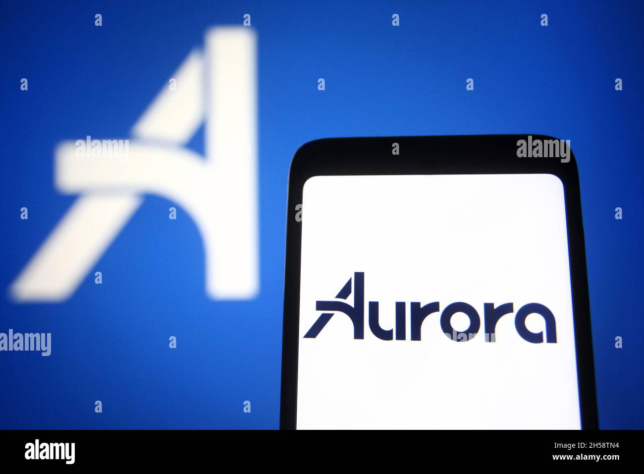 In this photo illustration, an Aurora Innovation Inc. logo is seen on a