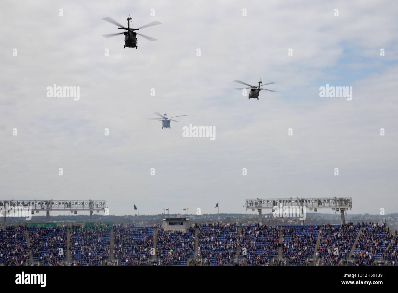 Maryland National Guard soldiers, from C Co., 2nd Assault Helicopter Battalion, 224th Aviation Regiment, Maryland National Guard, conduct a flyover during the national anthem on Oct. 24, 2021, at the M&T Bank Stadium, Baltimore. Four UH-60 Blackhawks flew over the stadium as part of the pre-game ceremonies. (U.S. Army National Guard photo by Staff Sgt. Elizabeth Scott) Stock Photo