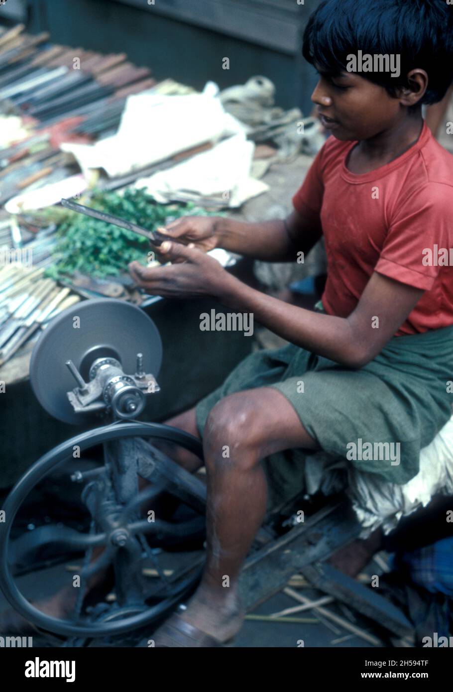 Child worker, boy knife sharpener, India Stock Photo Alamy